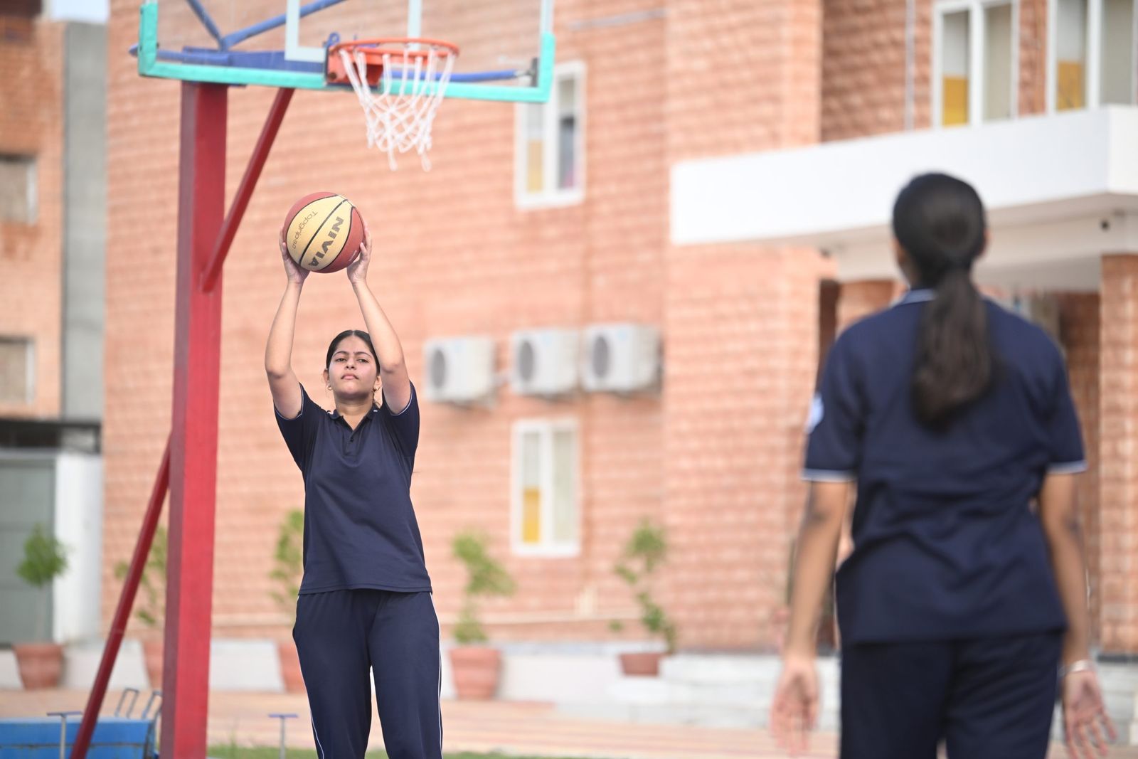 A child shooting at a basketball hoop.
