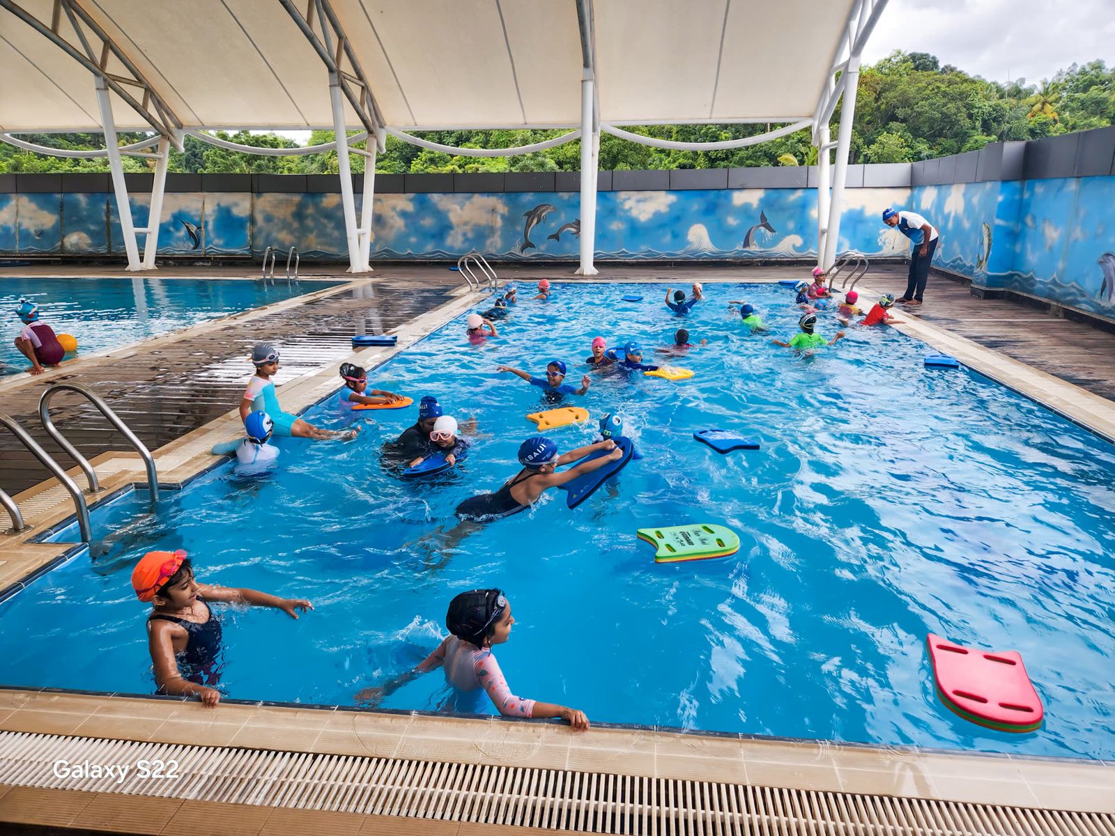 Children swimming lengths in a GEMS school pool.
