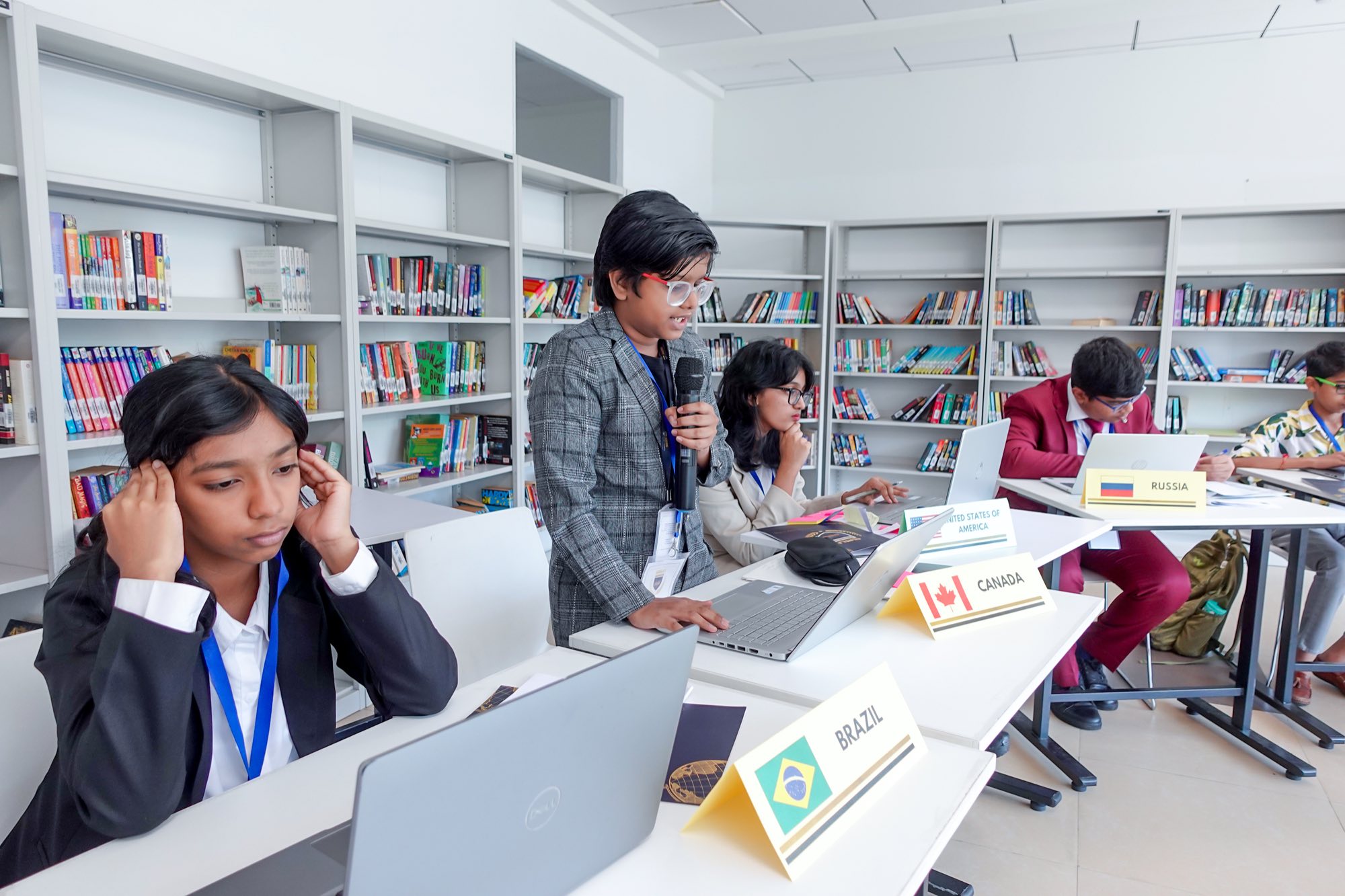Students at a Model United Nations session in the school library