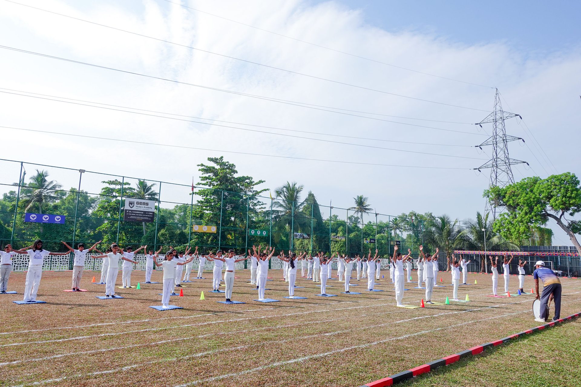 Students leading a mass yoga formation on the school field