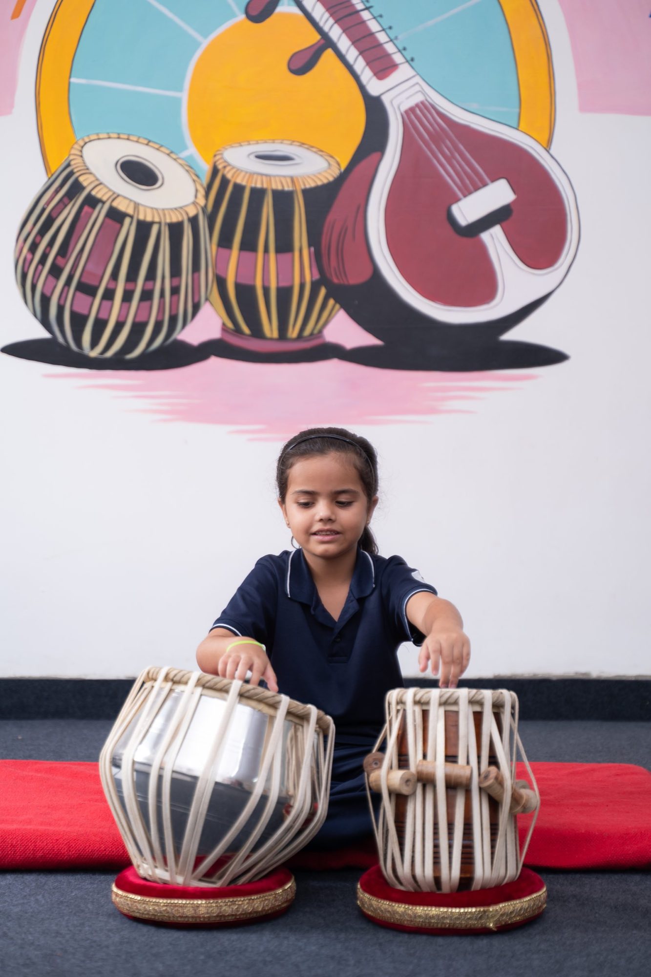 A student playing the tabla